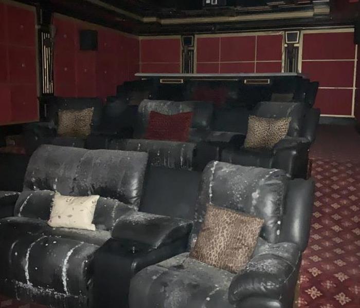 an in home movie theater covered in smoke and ash