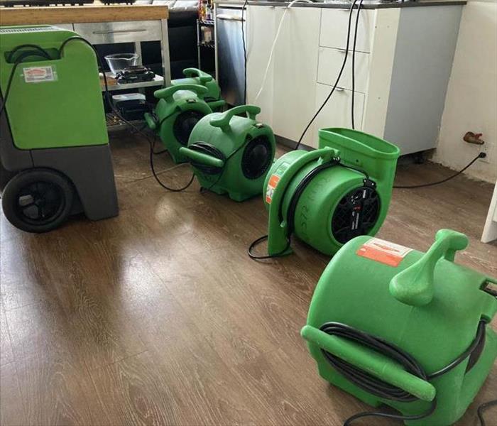 Drying equipment on floor in kitchen.