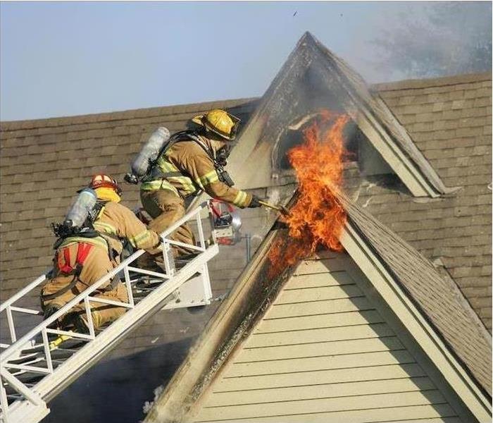 Firefighters putting out a fire in a house